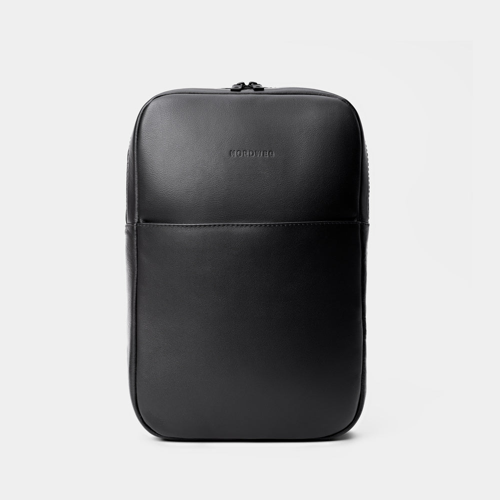 A single green leaf against a white background.